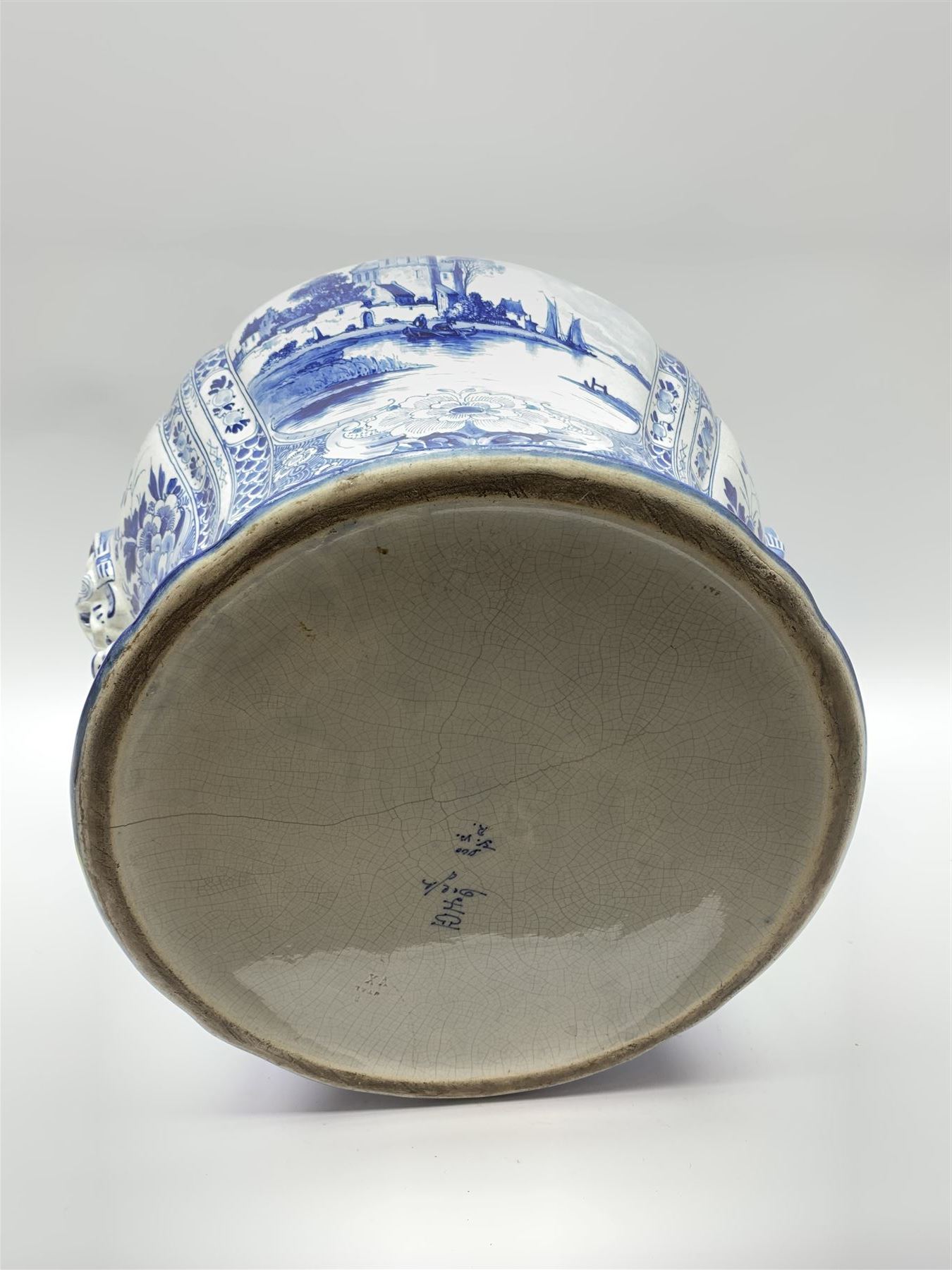 Large 20th century Delft blue and white jardinière, of baluster form with twin zoomorphic mask lug handles, decorated with hand painted panels of waterside scenes, within foliate surround, impressed and painted marks beneath for De Porceleyne Fles workshop, Delft, H35cm, rim D32