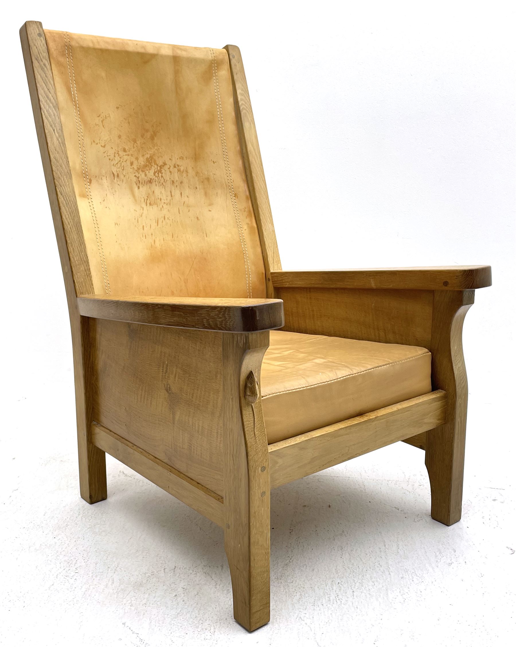 'Mouseman' oak smokers armchair, panelled sides, slung tan leather back and upholstered seat cushion, by Robert Thompson of Kilburn