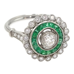 Platinum round diamond and calibre cut emerald target design ring, with diamond set shoulders