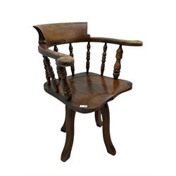 Early 20th century elm and beech smoker's bow type office chair, spindle back with dished seat, on four splayed supports