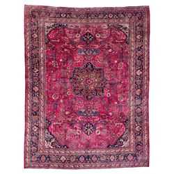 North East Persian Meshed fuschia ground carpet, the floral pole medallion flanked by bann...