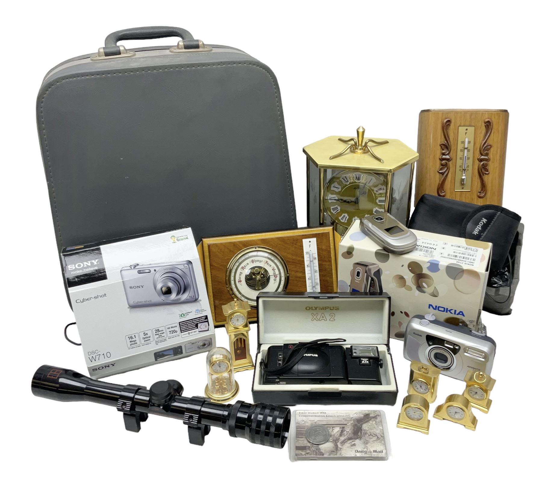 Kundo quartz clock, miniature brass clocks, two barometers, Sony digital camera, Nokia phone, Monarch Remington typewriter, commemorative Shilling etc