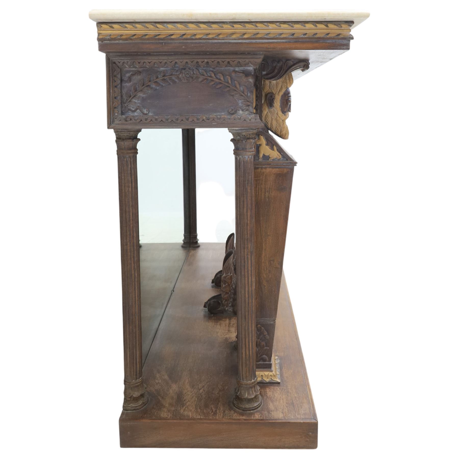 20th century carved hardwood console table in Renaissance taste, moulded marble slab top over a frieze decorated with festoons and roundels, the angles carved with grotesque mask brackets, supported by six fluted columns with carved mask and paw feet terminals, on a stepped plinth base with mirrored back