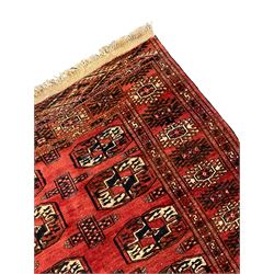 Bokhara red ground rug, decorated with two rows of Gul motifs, the border with geometric guard bands decorated with stylised plant motifs