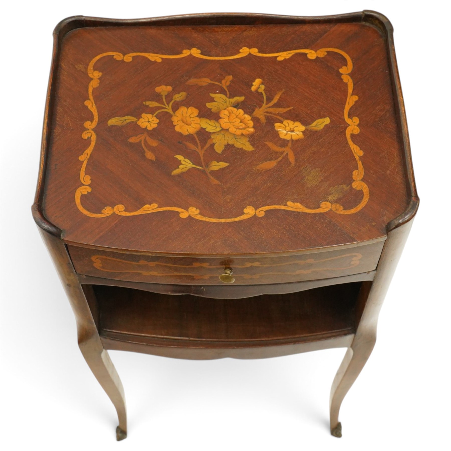 Matched pair of French inlaid floral marquetry bedsides, the three-quarter gallery tray top with central floral bouquet inlay and C-scroll border, one fitted with single frieze drawer over recessed cupboard and shaped apron, the other with three drawers, raised on tapering cabriole supports, with brass cartouche feet