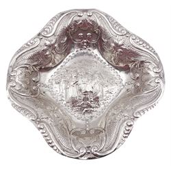 Dutch silver dish, of kite shaped lobed form, the centre embossed with figural scene, and the sides chased and repousse decorated with C scroll and foliate detail