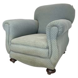 20th century traditional shape armchair, curved back and rolled arms, upholstered in light blue patterned fabric, on turned front feet