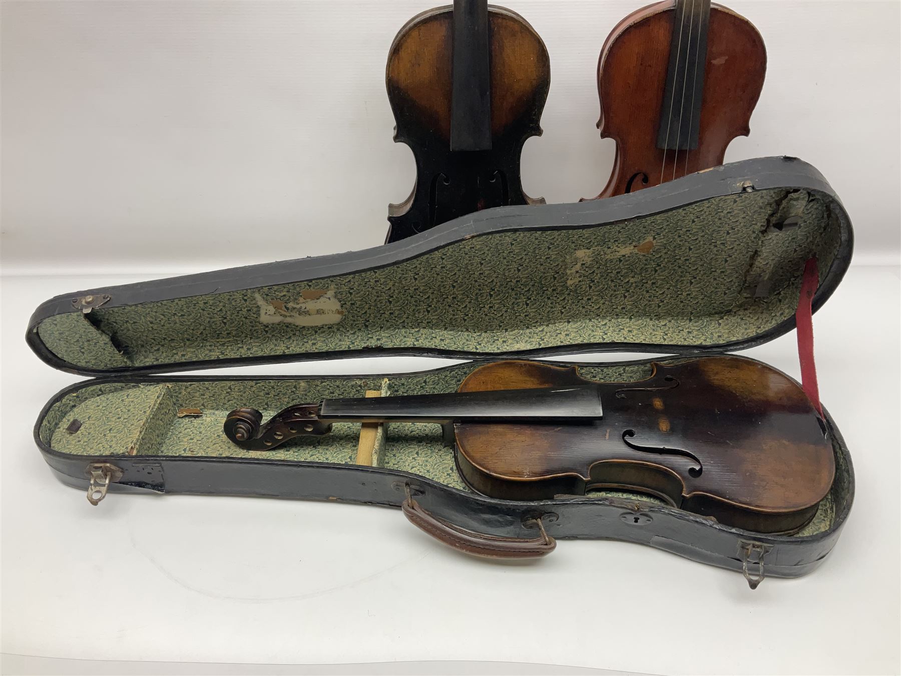 German violin c1890 with 36cm two-piece maple back and ribs and spruce top; bears label 'Antonius Stradivarius Cremona Faciebat Anno 1729' L59.5cm overall; in ebonised wooden 'coffin' case; and two German violins c1890 for completion - one bearing a Stradivarius label, the other a Ruggeri label; both in carrying cases (3)