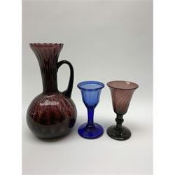 19th century amethyst drinking glass, the wrythen twist bell shaped bowl upon a knopped stem and circular foot, H11cm, together with a 19th century amethyst glass ewer, with lightly moulded bulbous body and fluted neck, H19cm, and a 19th century blue drinking glass, the ogee lightly moulded bowl with folded rim upon a conforming moulded stem and conical foot, H10.5cm