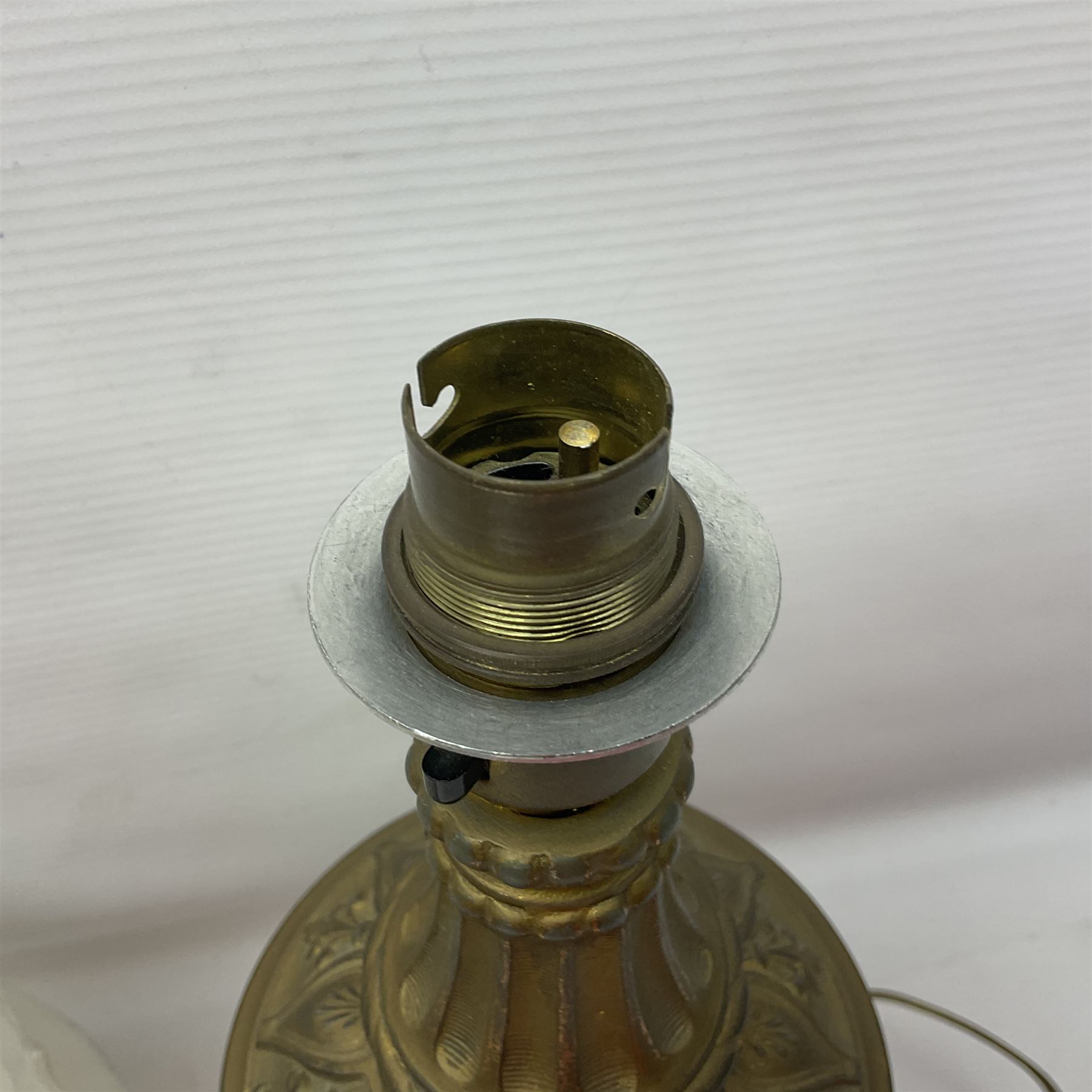 Gilt metal table lamp, heavily embossed with flowers and butterflies, with fluted frosted glass shade, H56cm