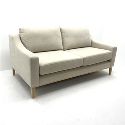 Three seat Noble & Jones  sofa, upholstered in a beige fabric, square tapering supports (W224cm) and a matching two seat sofa (W185cm)