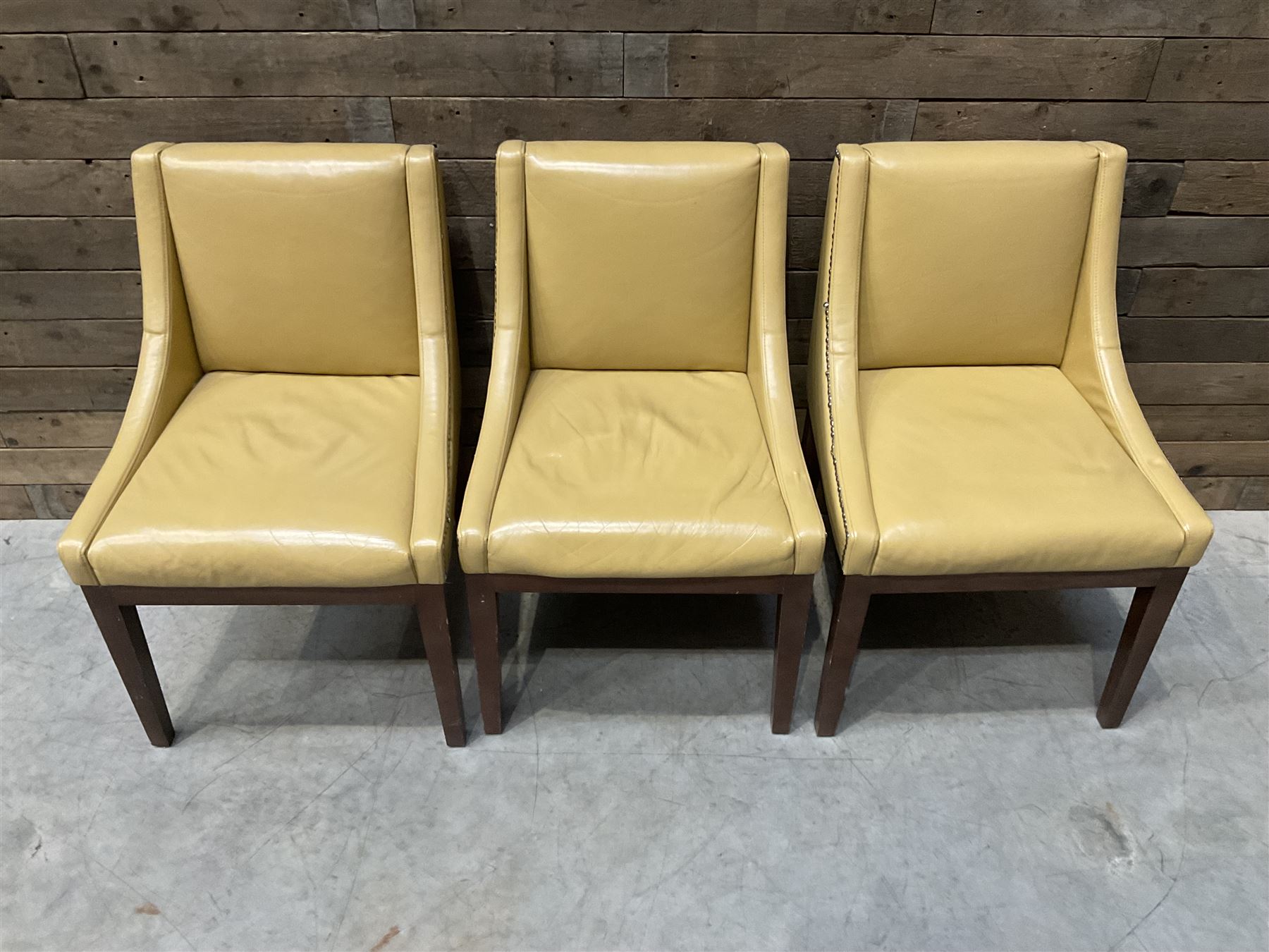 3 x walnut framed dining chairs, upholstered in a dark beige leather
