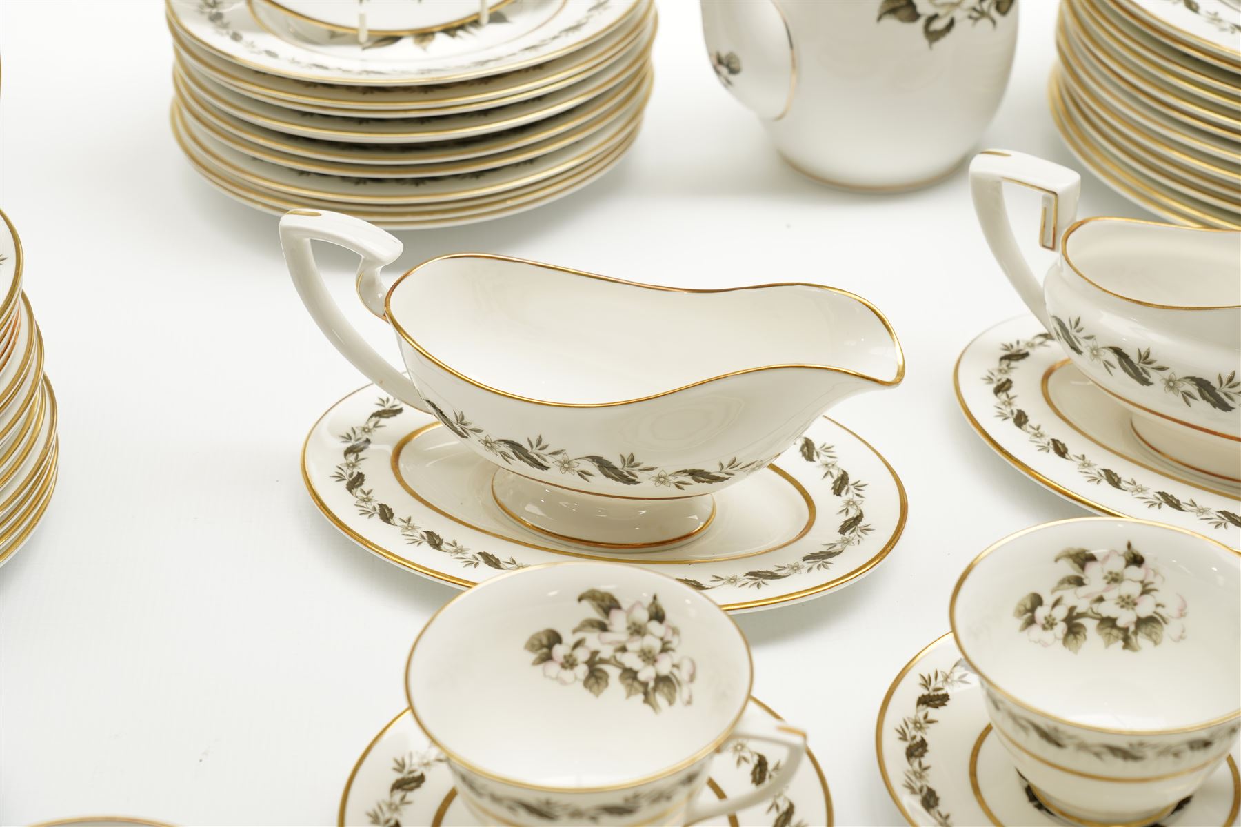 Extensive Royal Worcester Bernina pattern table service comprising thirteen dinner plates, twelve dessert plates, nine two handled soup bowls and stands, twelve side plates, three vegetable dishes and covers, pair of sauce boats and stands, two graduated oval meat plates, eleven tea cups, fourteen saucers, sixteen tea plates, coffee pot and eight coffee cups and saucers, (113 pieces) 