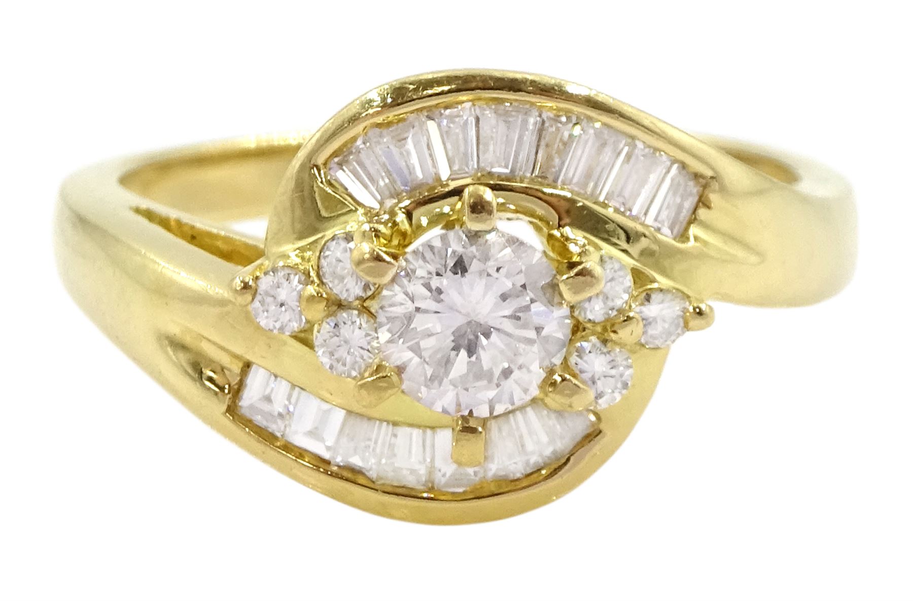 18ct gold diamond crossover ring, the central round brilliant cut diamond of approx 0.45 carat, with round brilliant and tapered baguette cut diamond surround, total diamond weight approx 1.00 carat
