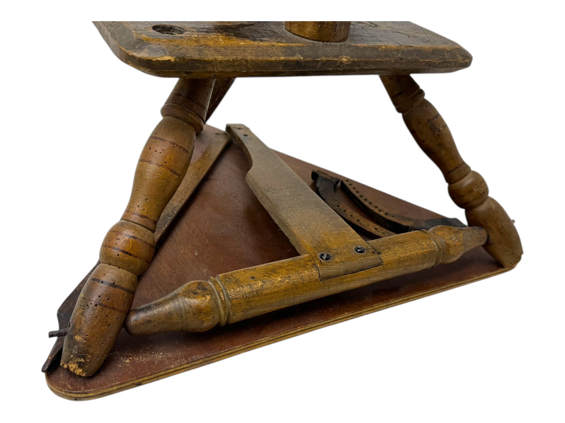 Late 19th century turned beech spinning wheel, upright form with single treadle, triangular base, and a flyer and bobbin assembly surmounted by a turned finial.