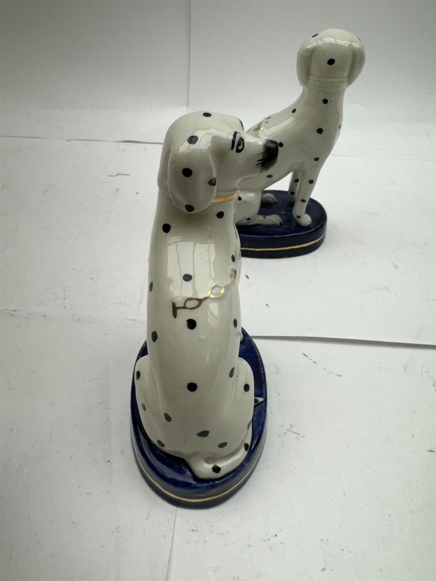 Pair of Staffordshire figures modelled as chained Dalmatians seated upon cobalt blue oval bases, H13cm, together with a Staffordshire pastille burner modelled as a castle, H12cm, a pair of 19th century Derby potpourri pots (lacking covers), and an 18th century blue and white tea bowl 