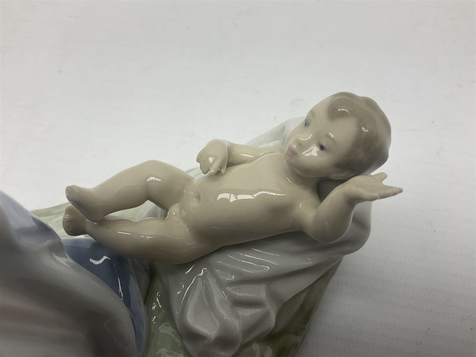 Lladro figure, Holy Night, modelled as Mary kneeling over baby Jesus, sculpted by Vincente Martinez, with original box, no 5796, year issued 1991, year retired 1994, H22cm