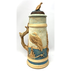  A large earthenware stein, decorated with a moulded continuous band of game birds, with confirming game bird finial to the cover and naturalistic modelled handle, H40cm.   