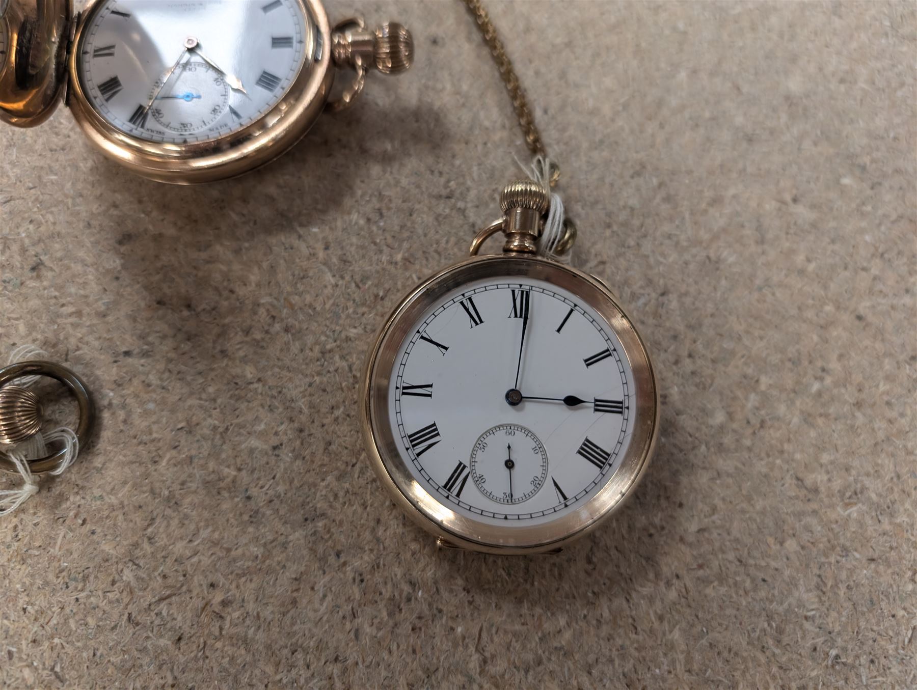 Four early 20th century gold-plated keyless pocket watches, three by Harris Stone Leeds, Waltham and Elgin and two gold-plated watch chains