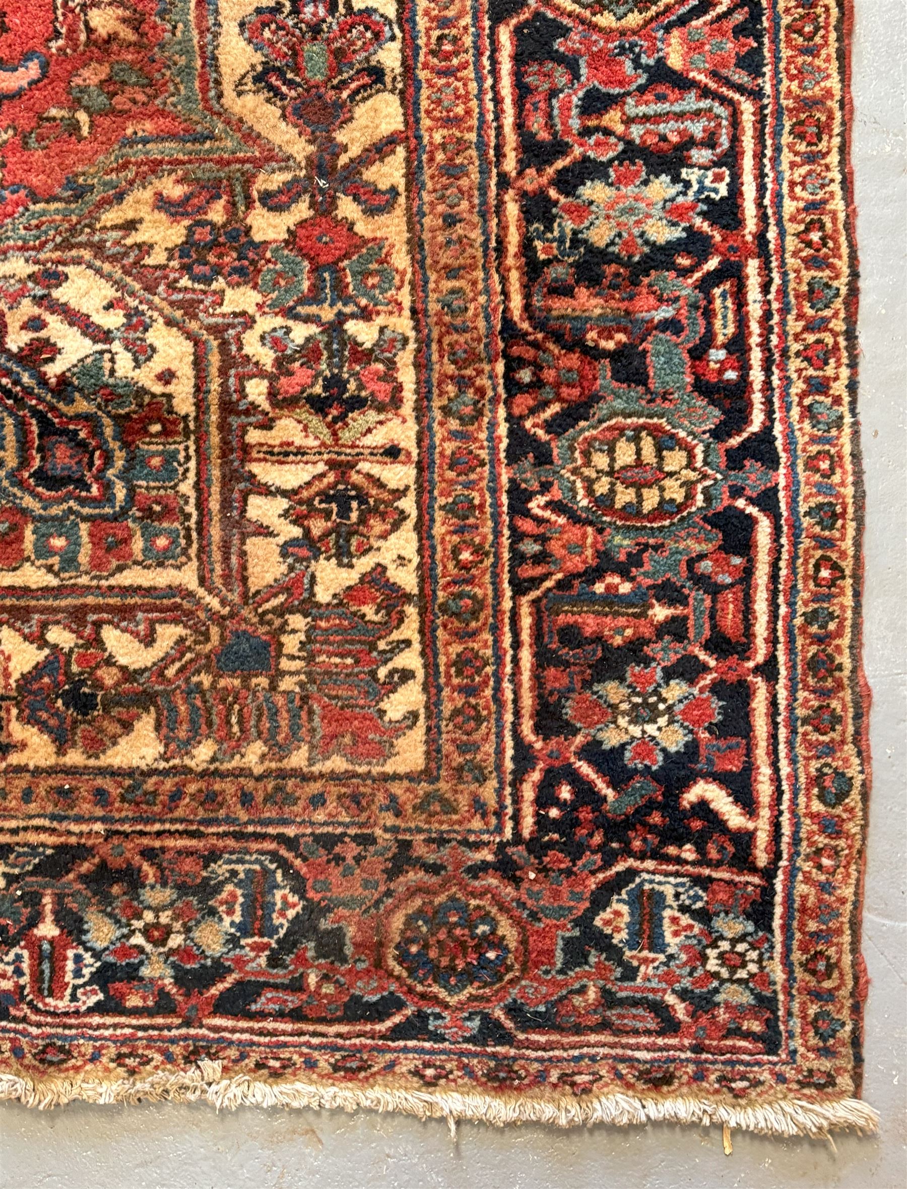 Persian Heriz red ground carpet, the field decorated with all-over geometric floral design within a guarded border, second quarter of the 20th century, 238cm x 339cm. - COLLECTION BY APPOINTMENT FROM: The White House, Thirsk Road, Easingwold, York, YO61 3NF - CALL 01723 507111 TO ARRANGE