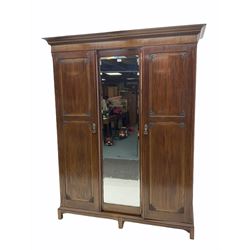 Early 20th century mahogany wardrobe, projecting dentil cornice over central bevelled mirror and two panelled doors, the interior fitted with hanging space and shelf