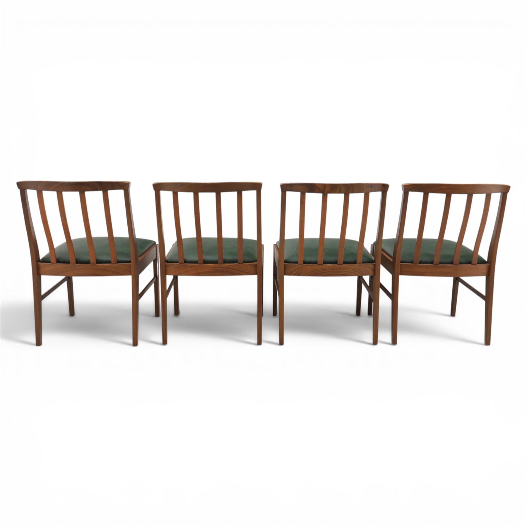 Mid-20th century teak dining table and chairs, with stowable fold over leaf, raised on square tapering legs, the chairs with teak frames and reupholstered green leather seats