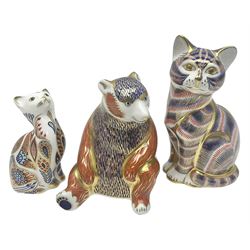 Three Royal Crown Derby paperweights, comparing Honey Bear and two seated cats, all with gold stoppers and printed marks beneath