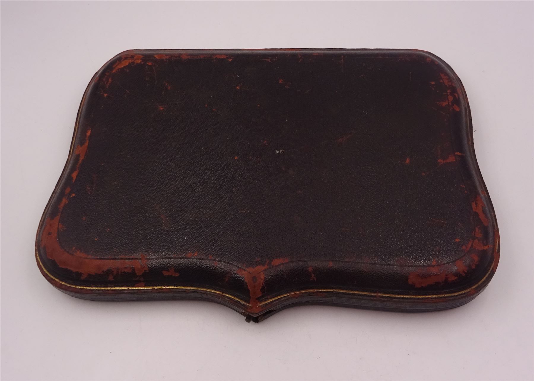 Set of ten Victorian silver coffee spoons, each with shaped scroll design rim, and a matching pair of sugar tongs, hallmarked Lee & Wigfull, Sheffield 1897, in tooled leather burgundy velvet and silk lined fitted case 