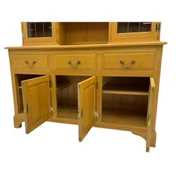 Solid light oak dresser, fitted with three drawers and three fielded panel doors, upper lead glazed display doors with open centre shelving
