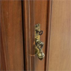 Edwardian walnut double wardrobe, fitted with two panelled doors, opening to reveal fitted interior with hanging space, three sliding linen trays and three drawers