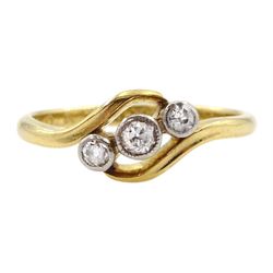 Early 20th century gold milgrain set three stone old cut diamond crossover ring, stamped 18ct