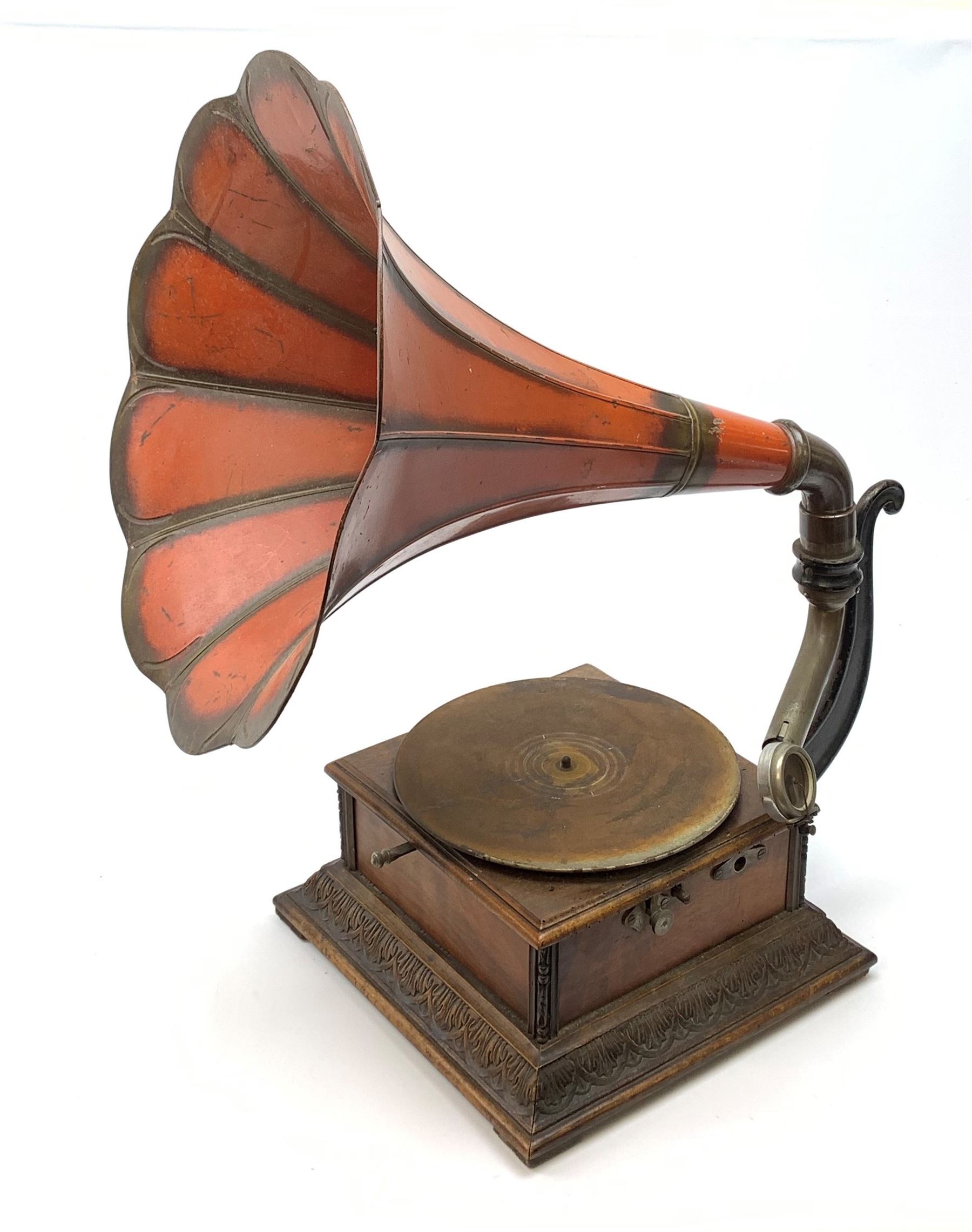 A wind up gramophone with red painted tin plate horn, upon a mahogany base, overall H71cm.