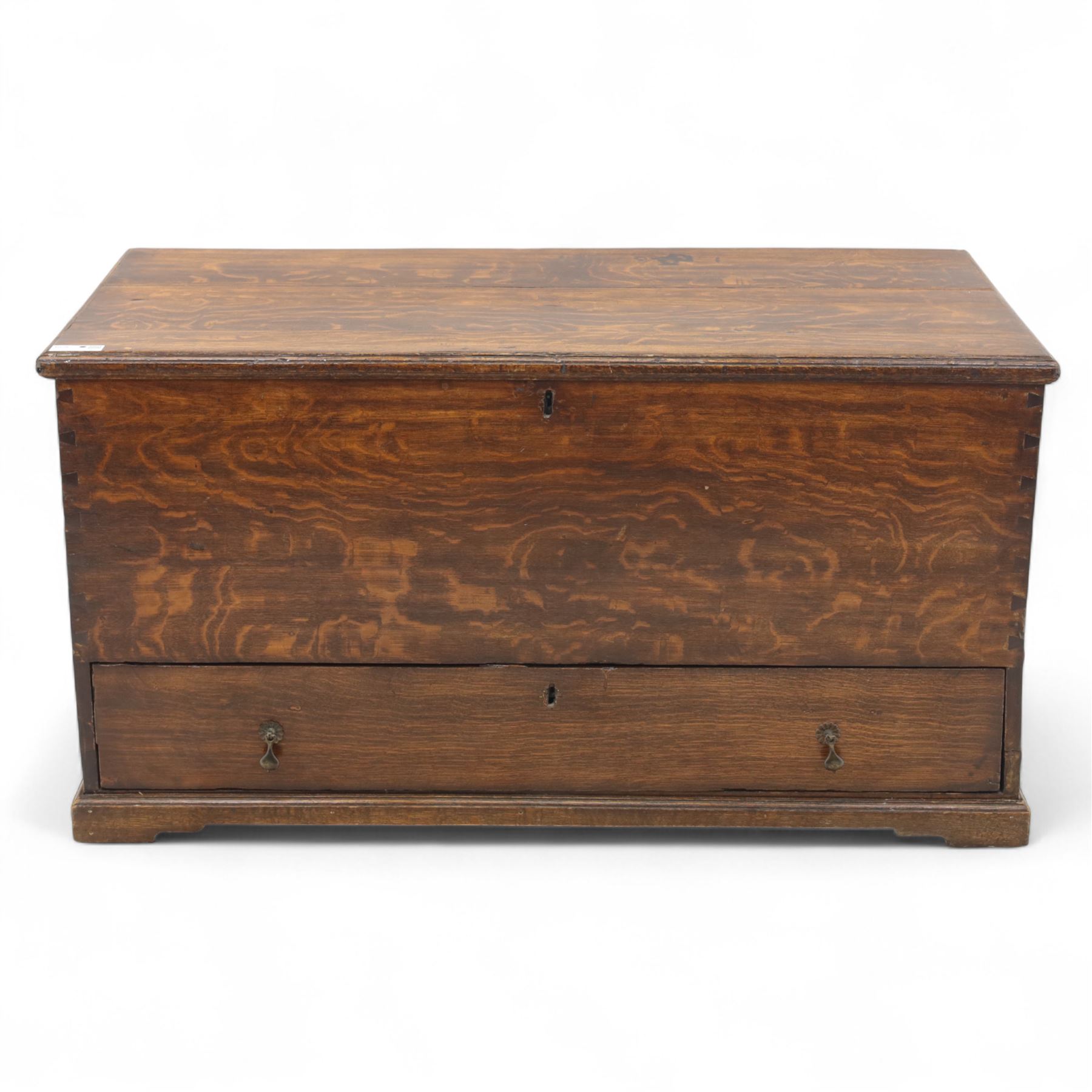 19th century oak blanket chest, rectangular hinged plank top with moulded edge, plain sides fitted with iron carrying handles, single full-width drawer to base with brass drop handles, on moulded plinth base