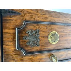 Victorian oak table top cabinet modelled in the form of a two door safe, the hinged twin doors with applied Royal crests opening to reveal one long drawer over two short drawers,