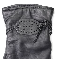 Hermès - pair of black leather gloves, lined in 100% cashmere, with pierced oval leather strap detail to cuffs, size 8