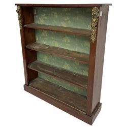 Early 20th century mahogany open bookcase, fitted with three shelves on plinth base, decorated with foliate patterned gilt metal mounts