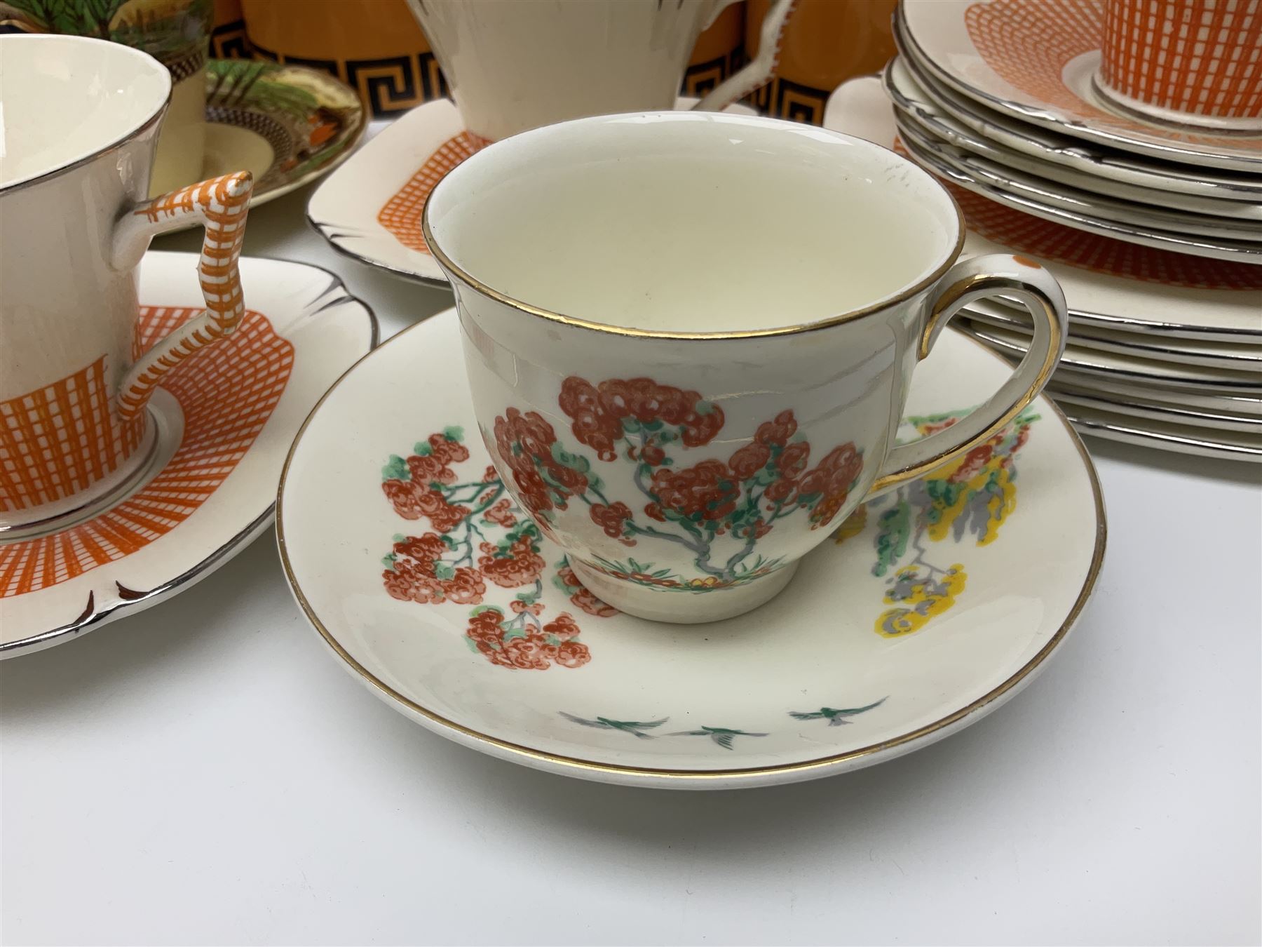 Four Portmeirion storage jars with Greek key pattern on an orange ground, together with Tams Ware tea service and other ceramics