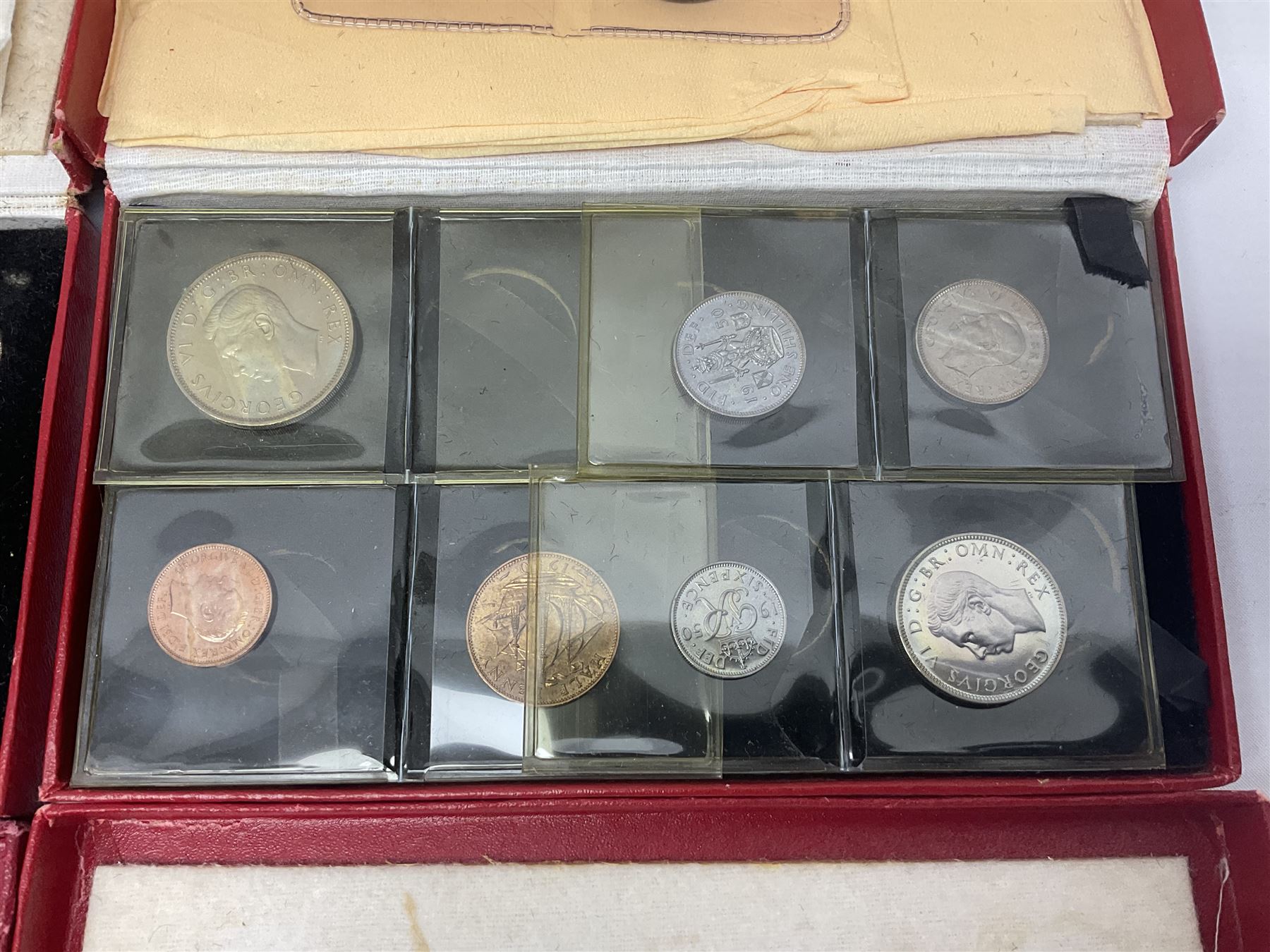 Four King George VI 1950 specimen coin sets, each comprising farthing, half penny, penny, threepence, sixpence, English  one shilling, Scottish one shilling, two shillings and half crown, each in red Royal Mint card case
