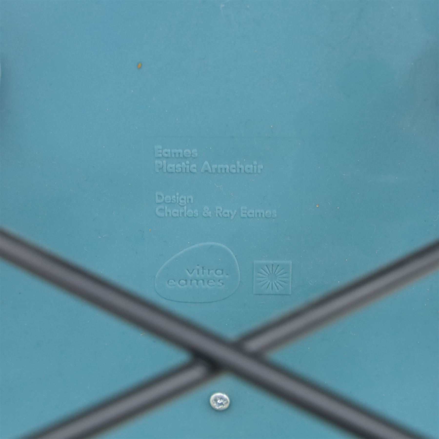 Vitra - Pair of Eames DAW armchairs, moulded plastic seats in teal with integrated armrests, blue upholstered seat cushions, supported on stained wooden dowel legs with black wire cross bracing