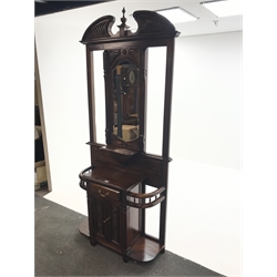 Victorian style mahogany hallstand, swan neck pediment with central finial above bevel edged mirror back , single drawer, two carved doors, W99cm, H223cm, D40cm