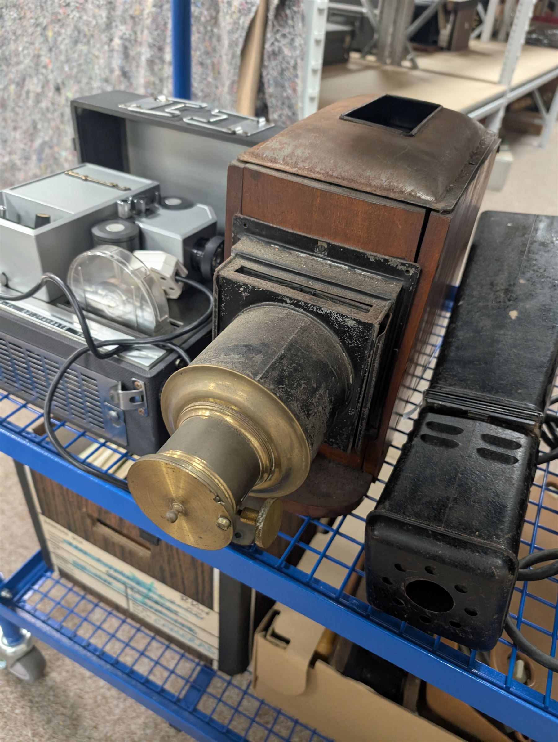 Collection of projectors, epidiascopes, magic lantern and similar, including Bell & Howell 621 projector, mahogany and brass magic lantern, Helper 6S projector, Leitz epidiascope, Zeiss epidiascope, Johnson Optiscope, etc