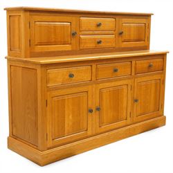 Knightman - Yorkshire oak dresser, the upper section fitted with two drawers flanked by two hutch cupboards, rectangular top over three drawers and fielded panelled cupboard, on skirted base, carved with knight signature, by Horcace Knight of Thirsk