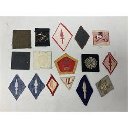 Approximately one-hundred printed and embroidered cloth badges including I, II, VIII, XI, XII and XXX Corps, Eastern Command, various Armoured Divisions, Midland, Wessex, Home Counties and 12th Infantry Brigades, Salisbury Plain, Northumberland, Hampshire, North Midland, West Riding, Essex and Suffolk Districts, Berlin & Rhine Army Troops etc