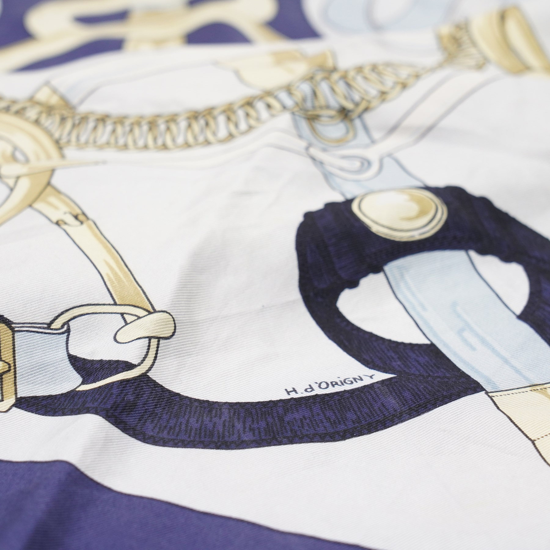 Hermès - ‘Éperon d’Or’ silk scarf, designed by Henri d’Origny, first issued 1974, navy, pale blue, ivory and gold colourway with hand-rolled edges