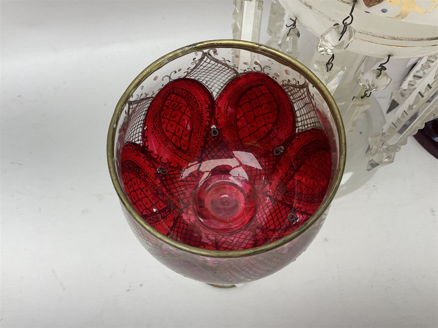 Bohemian red glass lustre, painted with stylised floral and foliate decoration, together with a milk glass example and two bohemian goblets converted to lustres 