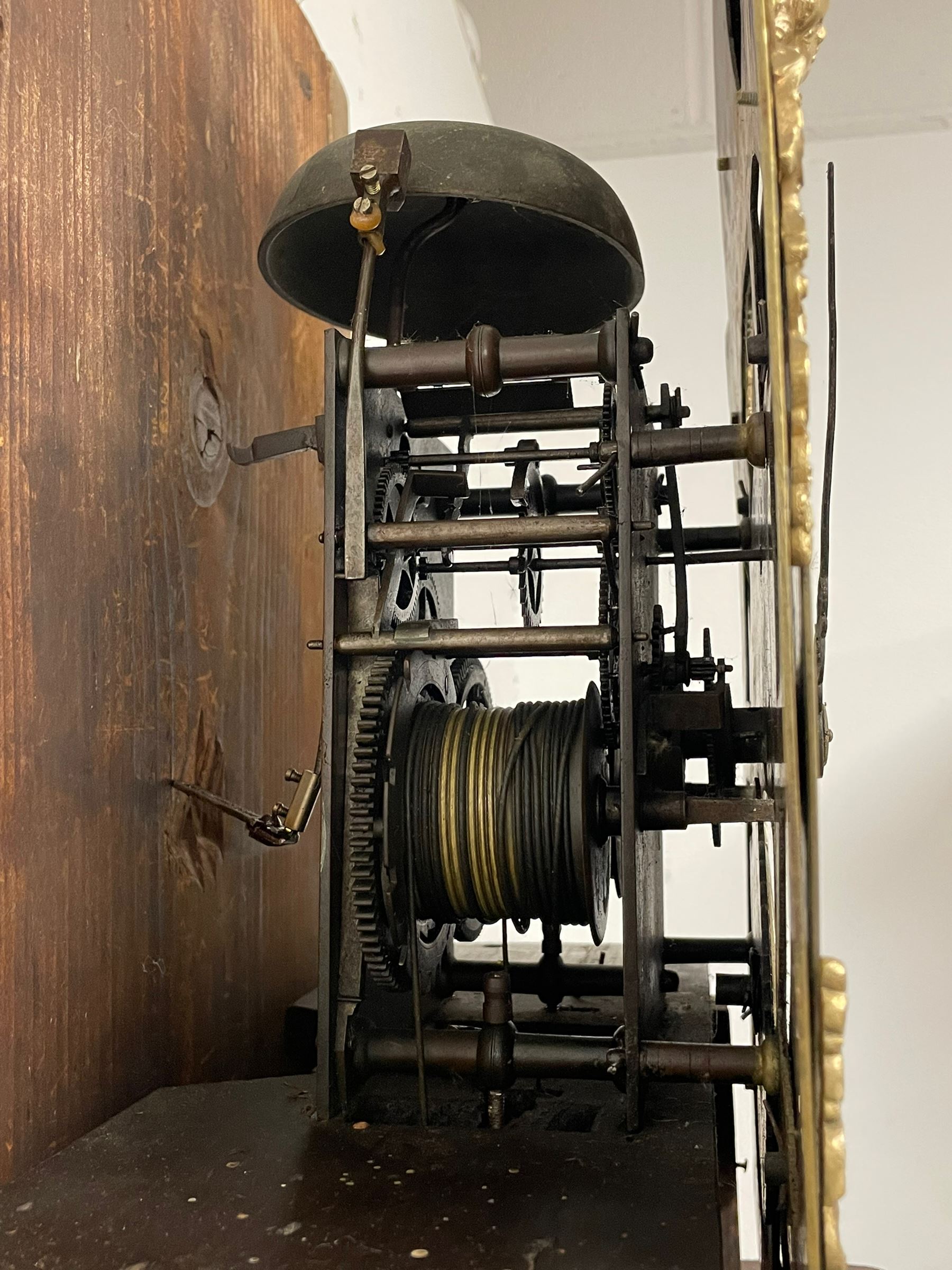 Thomas Hutchinson of Leeds - 18th century 8-day oak longcase clock with as broken arched  pediment and moulded cornice, with a conforming hood door flanked by plain turned pilasters with gesso capitals,  long trunk door with a wavy top on a square plinth with a raised panel, brass dial with cast spandrels,  engraved silvered dial centre and chapter ring with Roman numerals, five minute Arabic's and minute track, with pierced steel hands, seconds pointer,  arched calendar aperture and silvered boss engraved with the makers name to the break arch, dial pinned to a rack striking two train movement with a recoil anchor escapement. With weights and pendulum. Thomas Hutchinson is recorded as working in Leeds from 1760-90.