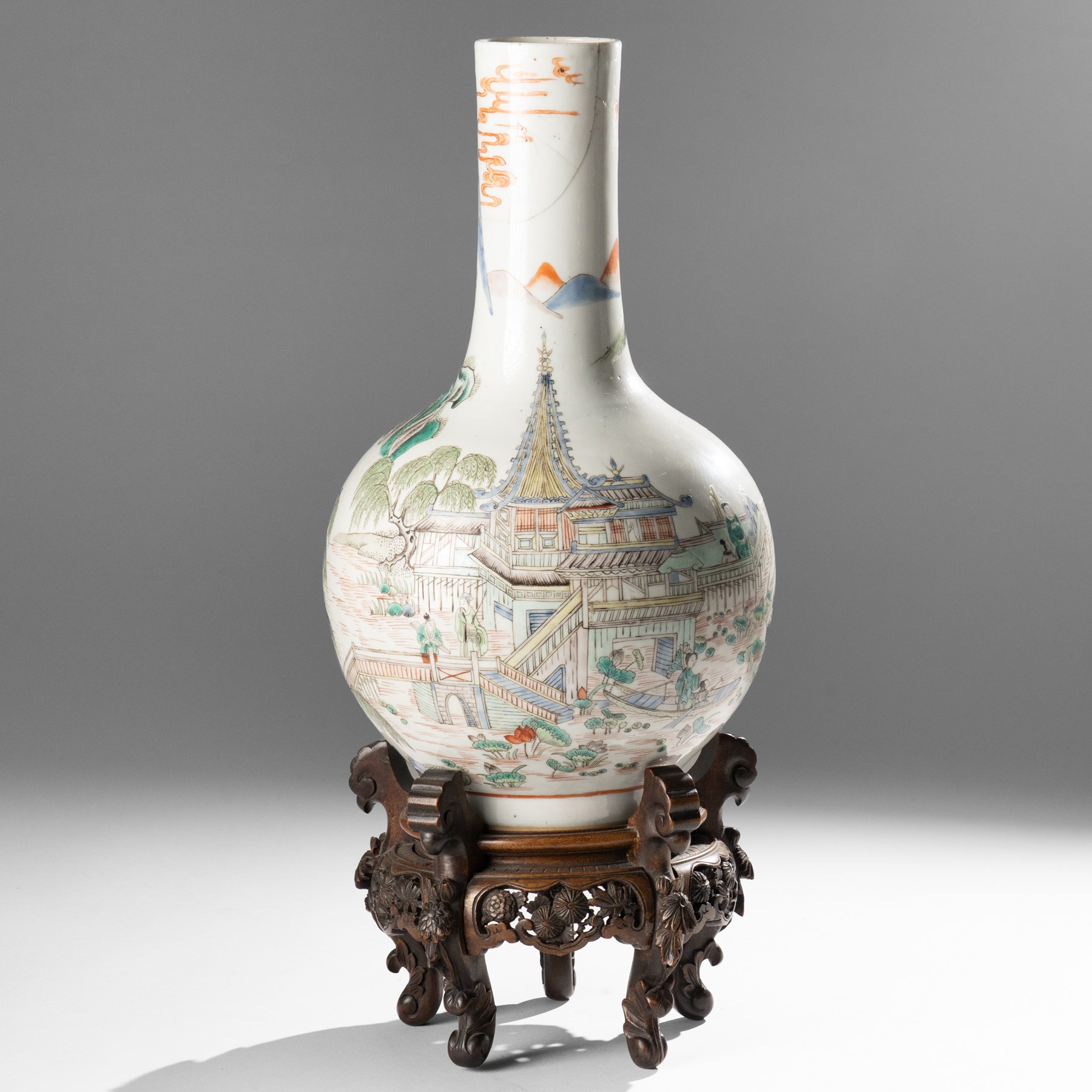 Chinese Kangxi period famille verte vase, the body finely painted with a continuous narrative scene of figures inside and out of a pavilion complex, beside a river, rocks and trees, character mark to base, raised upon a hardwood stand, overall H47cm