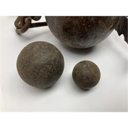 Late 19th/early 20th century prisoners iron ball and chain, with leg manacle; small cannon ball and grape shot
