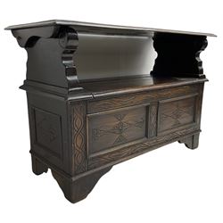 17th century design stained oak monks bench, hinged metaphoric table back, over hinged box seat compartment, the panelled front carved with foliate decoration and lozenges