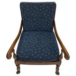 Early 20th century stained beech framed armchair, cane panel back over scrolled arm terminals, raised on turned supports united by turned H-stretcher, with patterned blue upholstered loose back and seat cushions